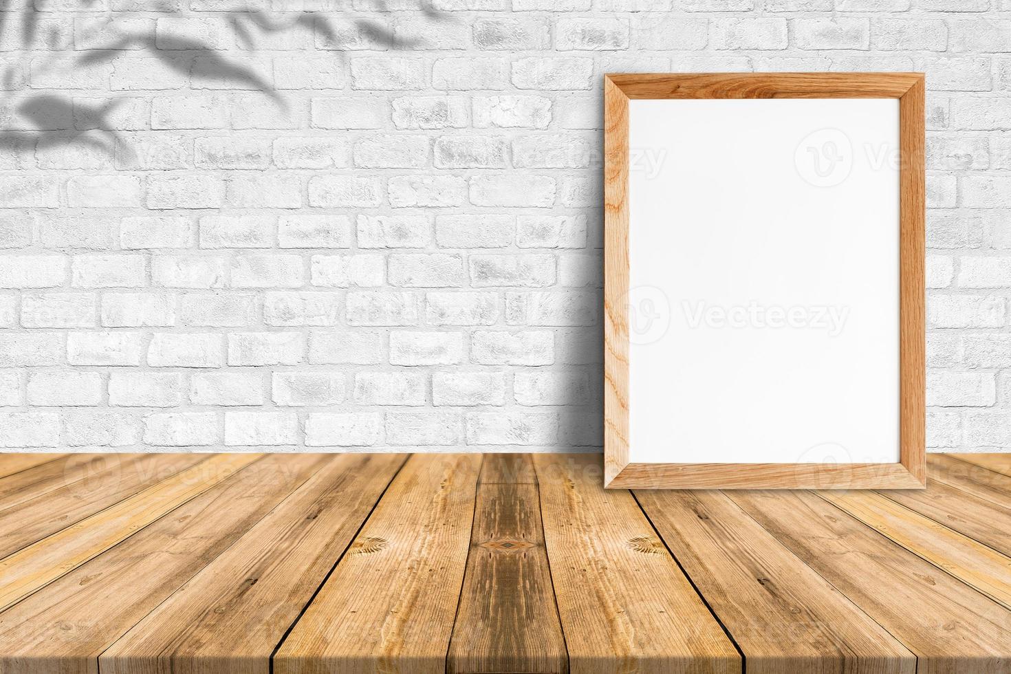 Blank wood frame on tropical wood floor and white brick wall,template mock up for adding your content photo