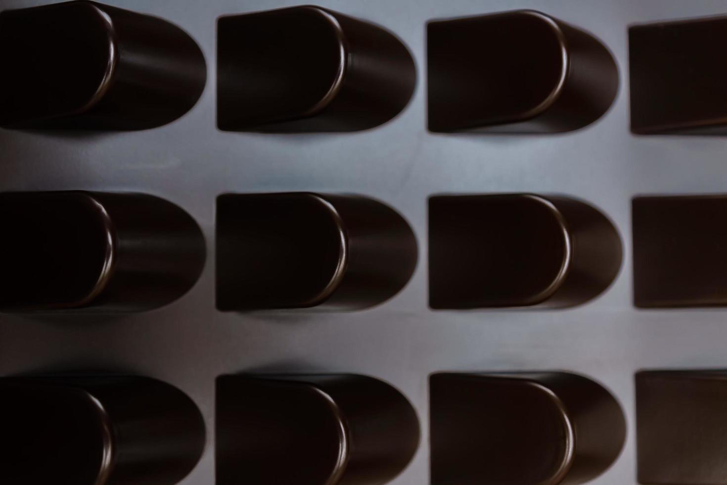 empty box of chocolate shapes. Abstract texture background photo