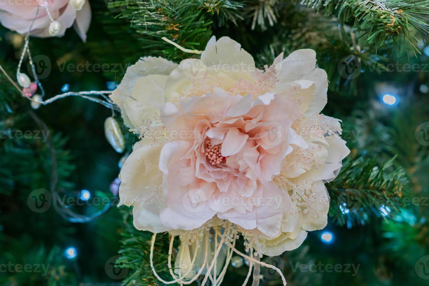 close up of christmas tree decorated with tender pink flower. photo