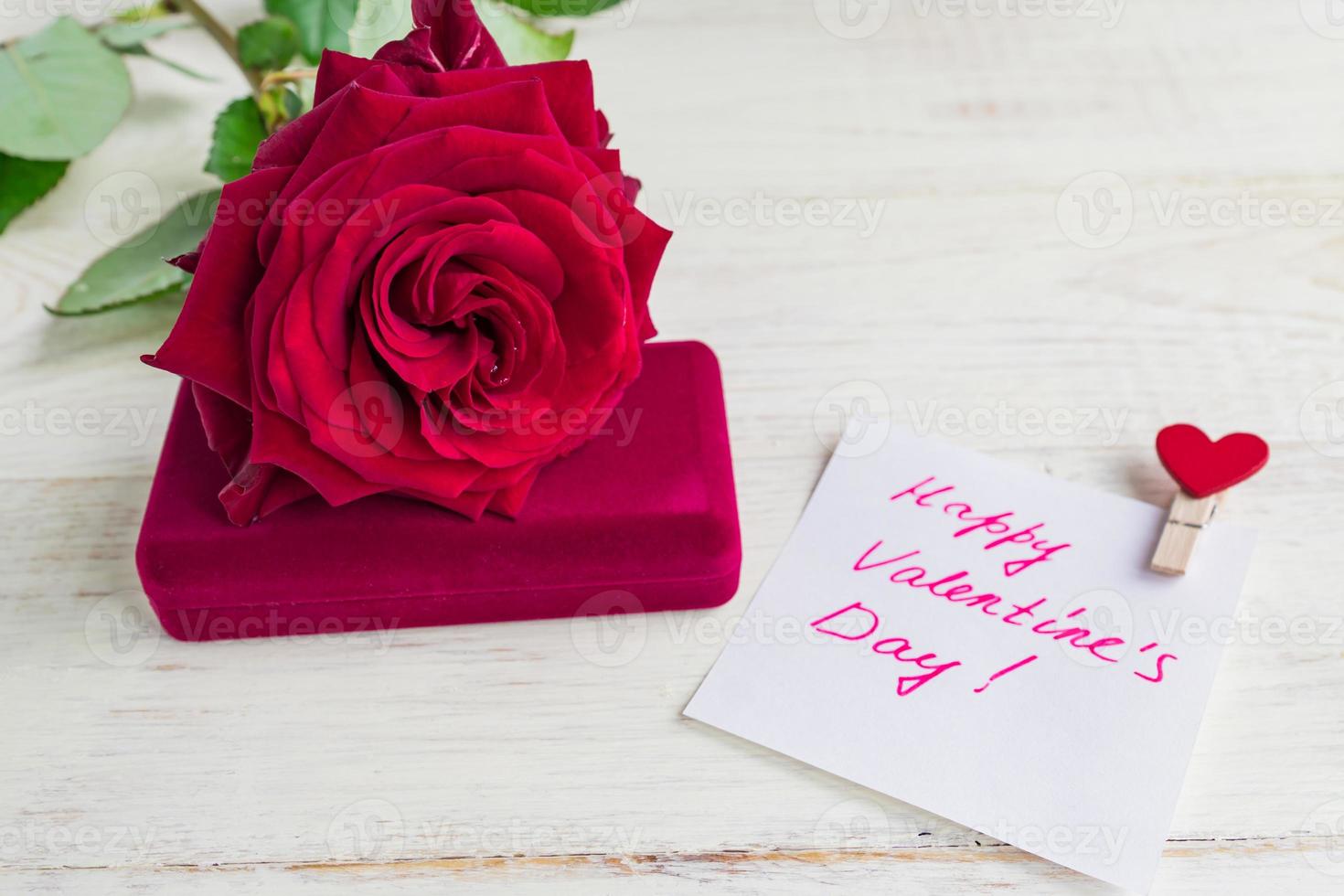 jewelry gift box and bautiful red rose on wooden background. Present for Valentine's day photo