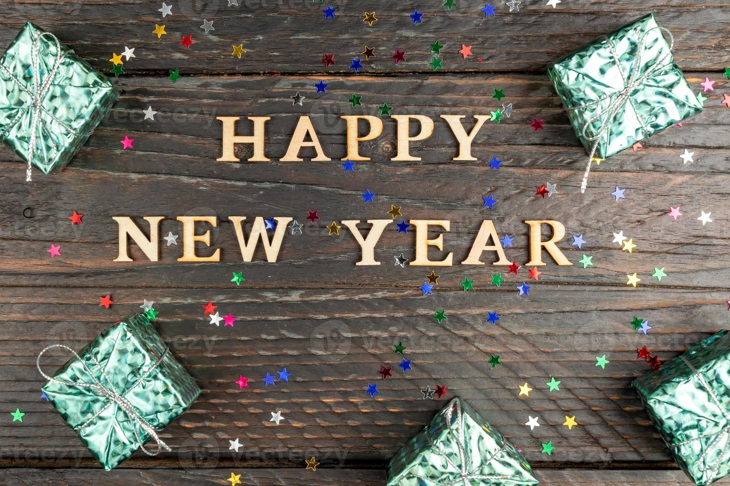 Blue glitter gift boxes. New year presents on wooden table. Tex Happy new year. Festive greeting card. Flat lay. photo