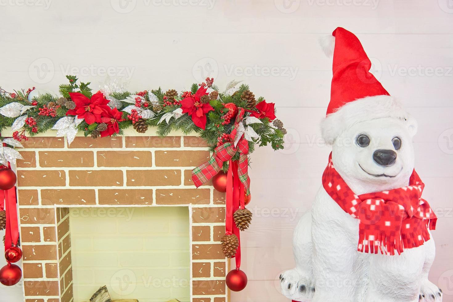 Polar bear with christmas fireplace decorated with balls and bows. Christmas room interior. photo