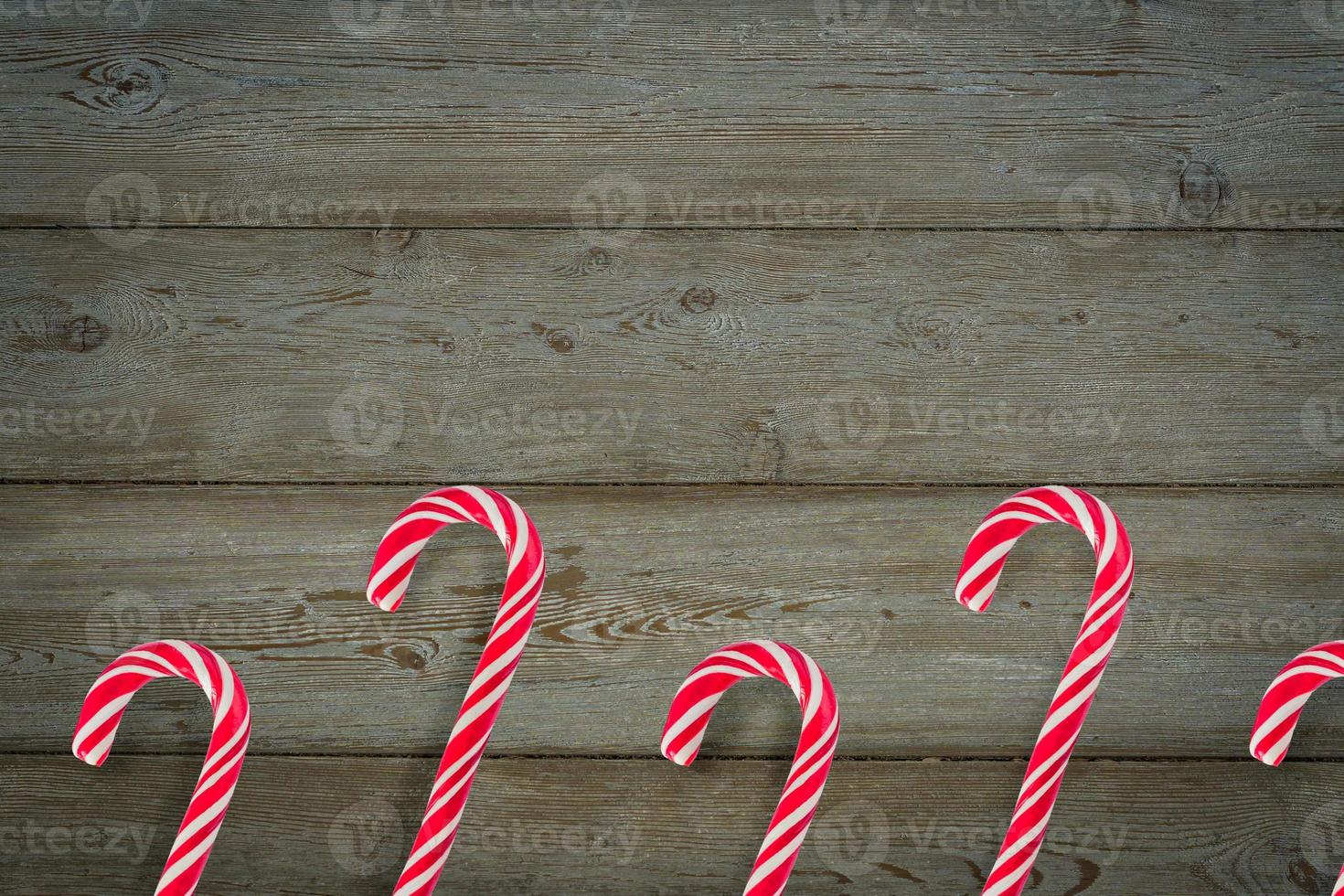 Traditional Christmas candy canes on wooden background. photo