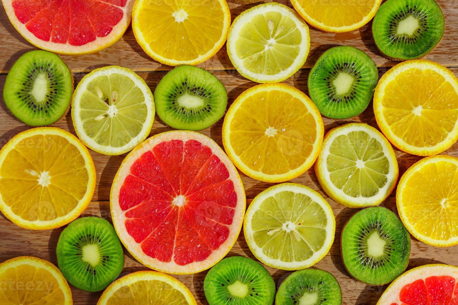 frame with slice of oranges, lemons, kiwi, grapefruit pattern isolated on white background. photo