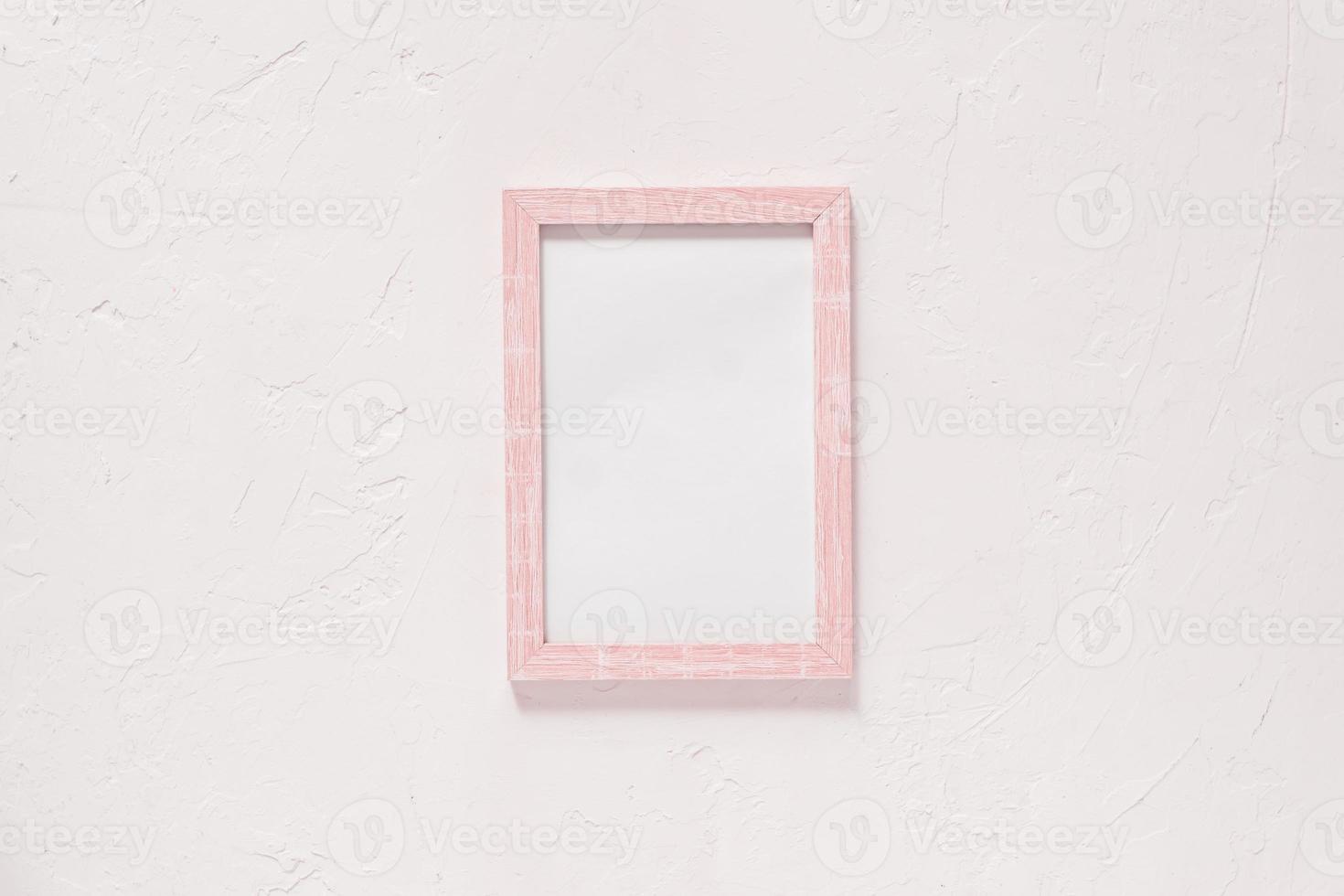 wooden photo frame on white wall baxkground. Minimal flat lay with copy space. Toned