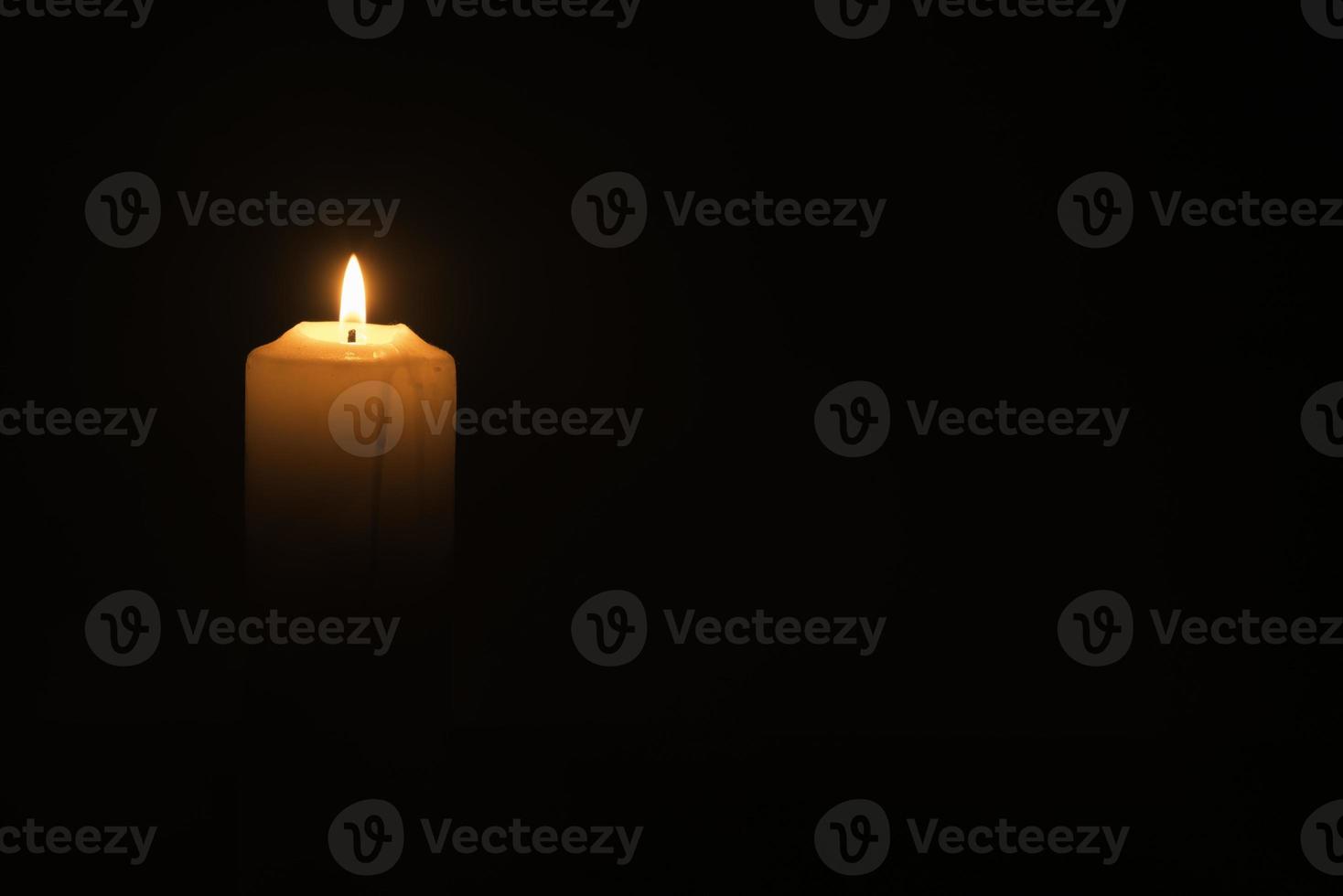 Candlelight on the black background photo