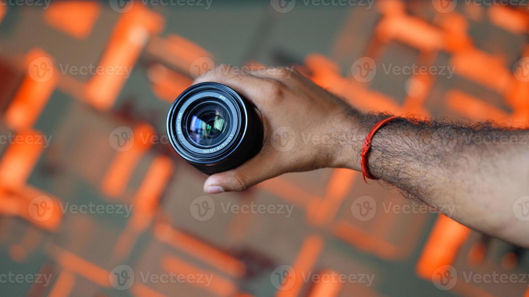 lens holding hand horizontally image photo