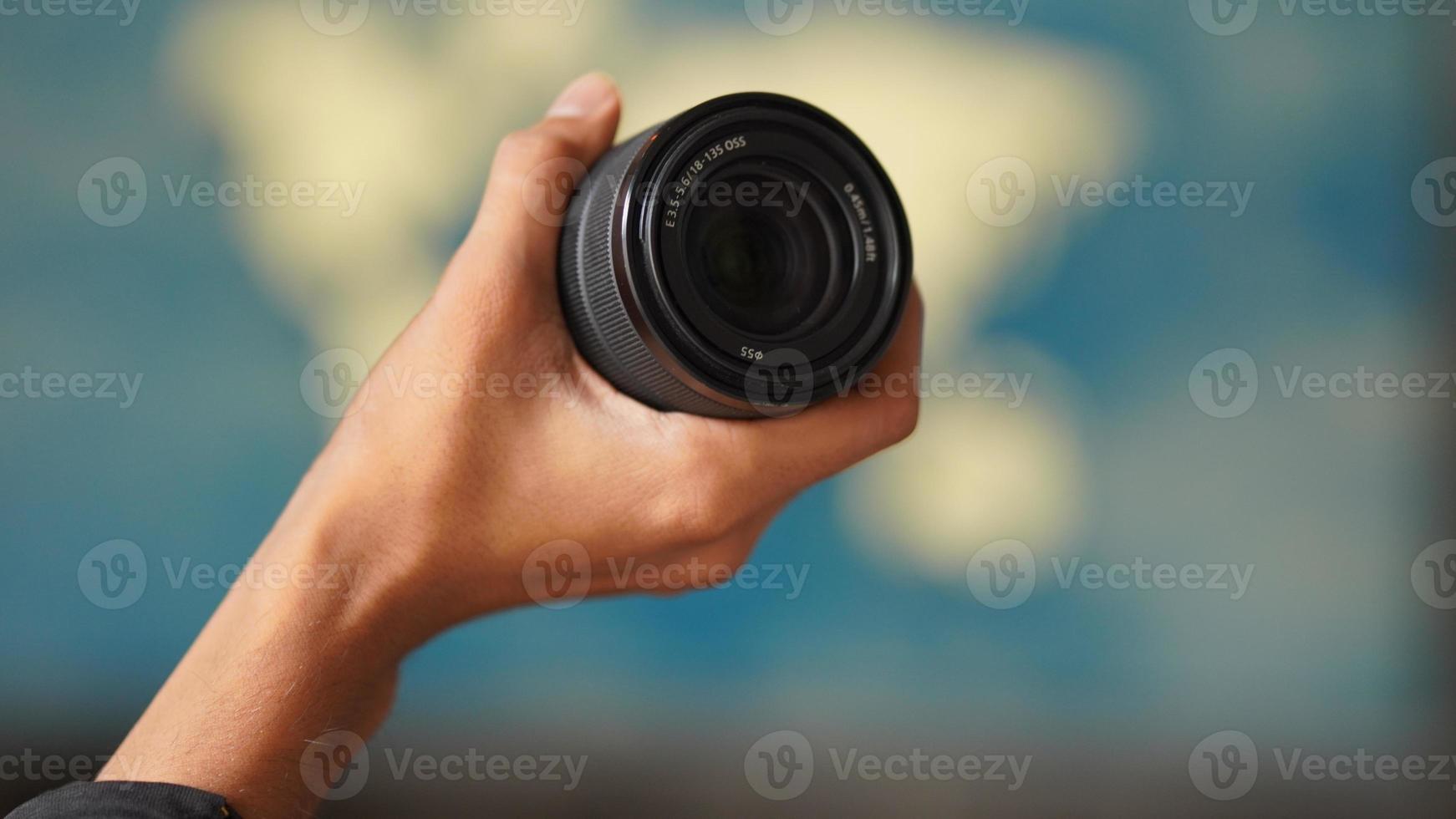 image of lens holding in hand photo