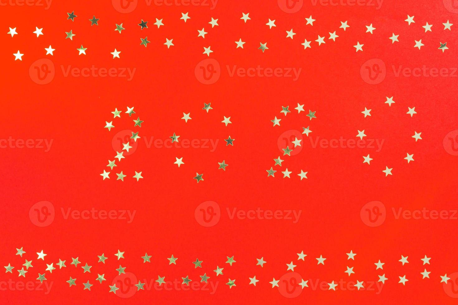 Happy New Year 2020 winter holiday greeting card design template. Party poster, banner or invitation silver glittering stars confetti glitter decoration on red background photo