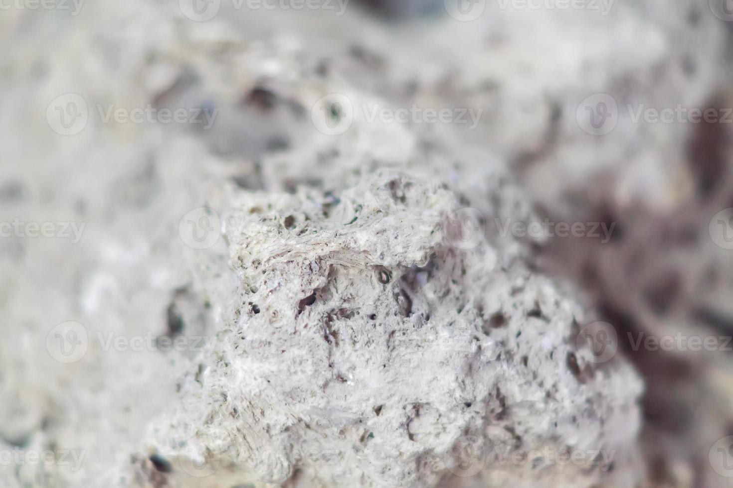 close up of gray stone texture with holes. Natural background photo