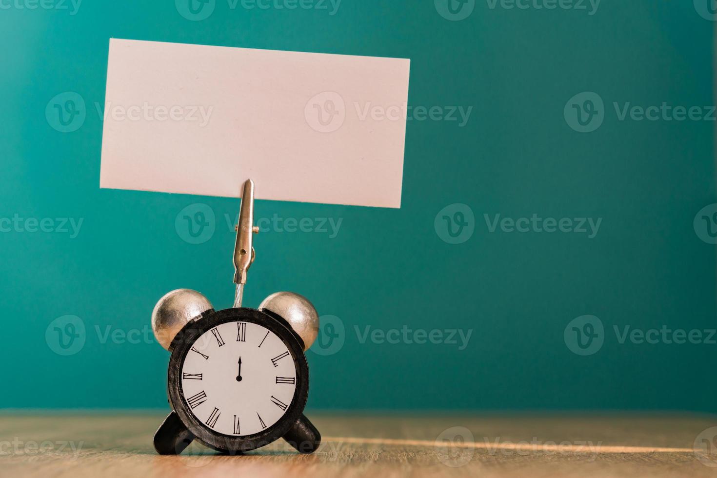 Alarm clock and banner with copy space on wooden table. Time management concept. photo