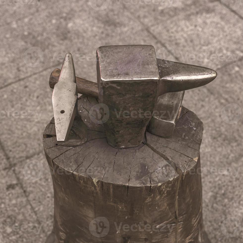 A hammer near anvil. Tool using in a blacksmith shop photo