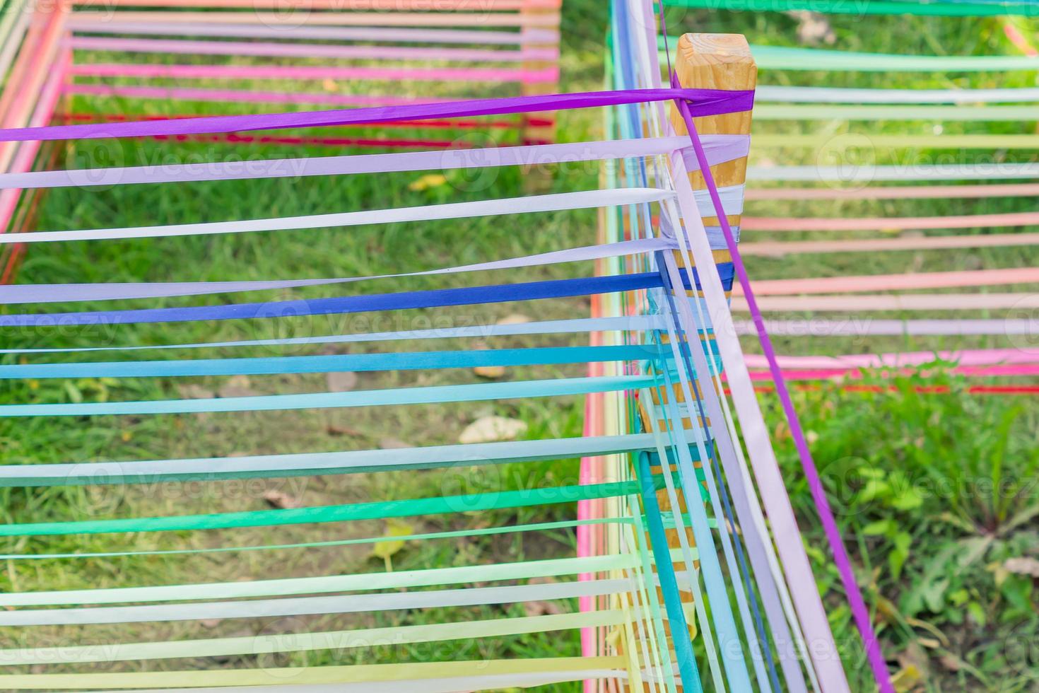 Children's labyrinth on playground made of multicolored satin ribbons.. photo