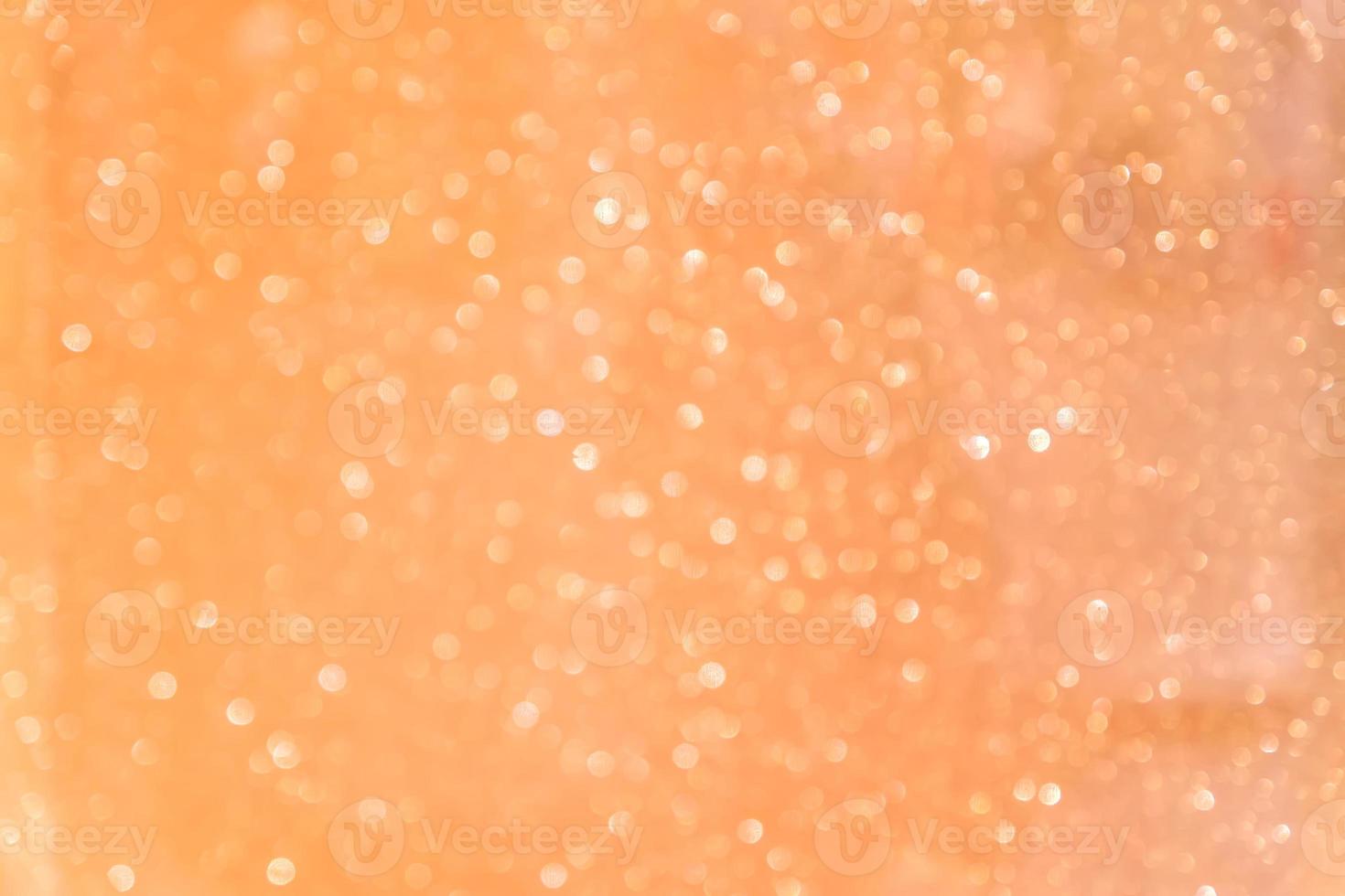 Bokeh abstract texture. Beautiful christmas background in orange colors. Defocused photo