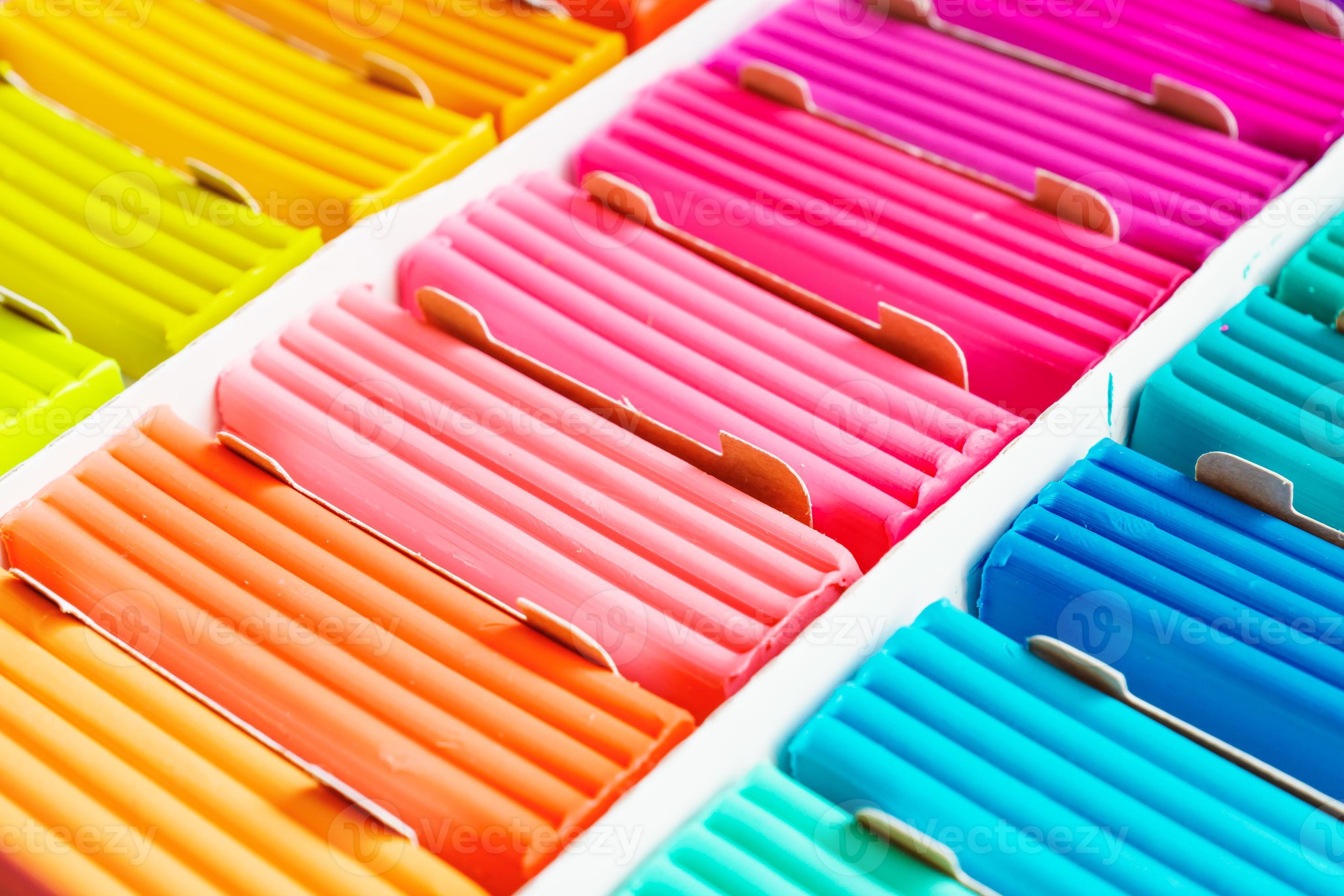 Rainbow colors of modeling clay. Multicolored plasticine bars ina box,  background texture 10602231 Stock Photo at Vecteezy