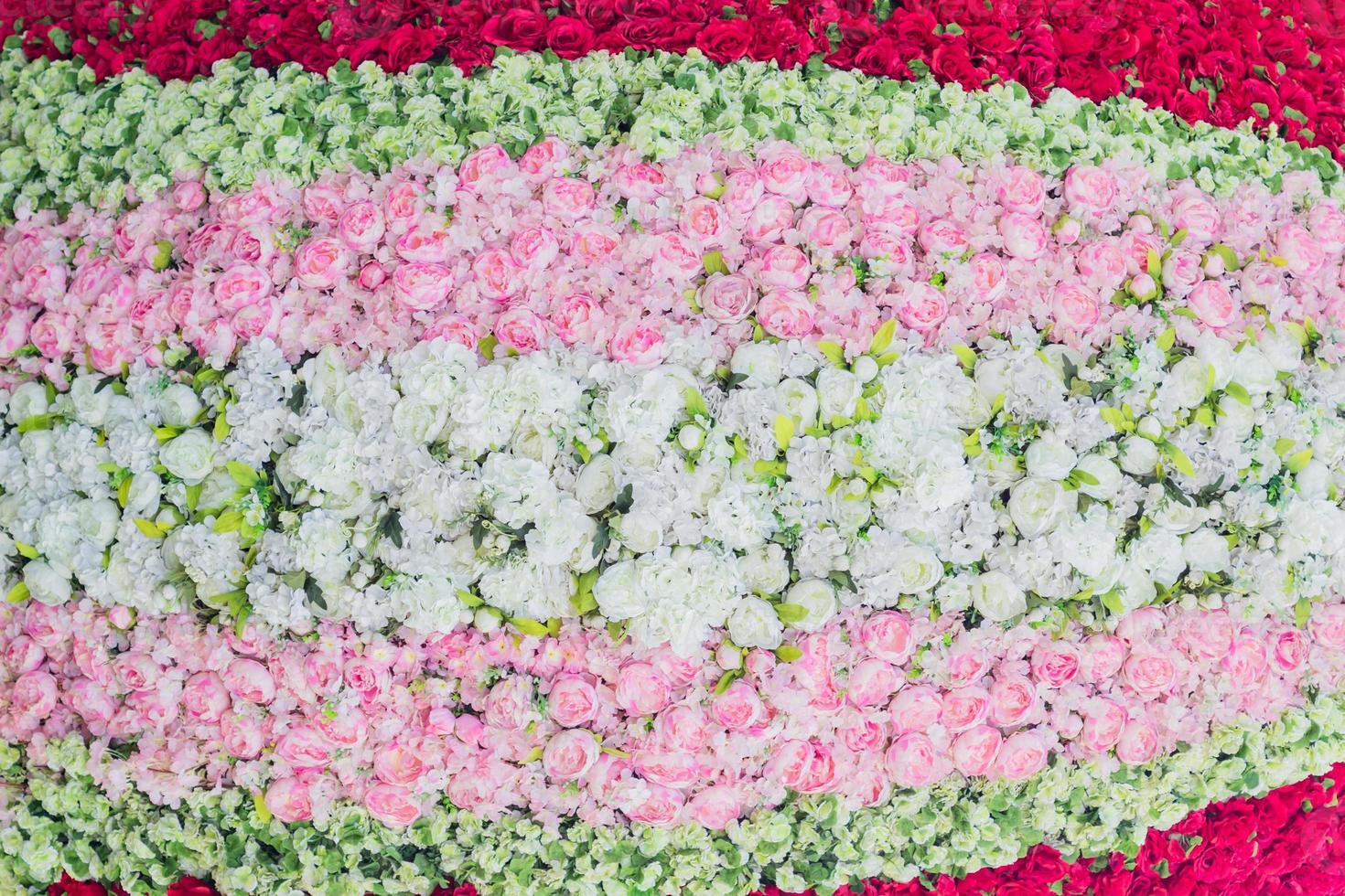 artificial blooming peonies and roses of white, red and pink color background photo