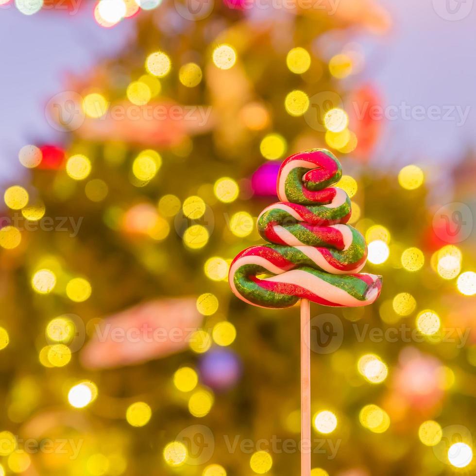 Christmas tree candy on festive bokeh background. photo