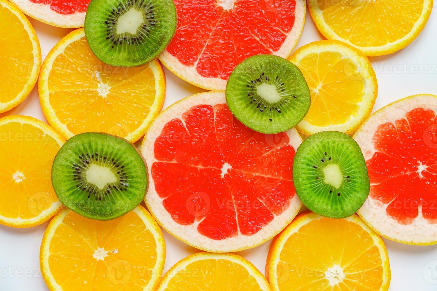 citrus slice, kiwi, oranges and grapefruits on white background. Fruits backdrop photo