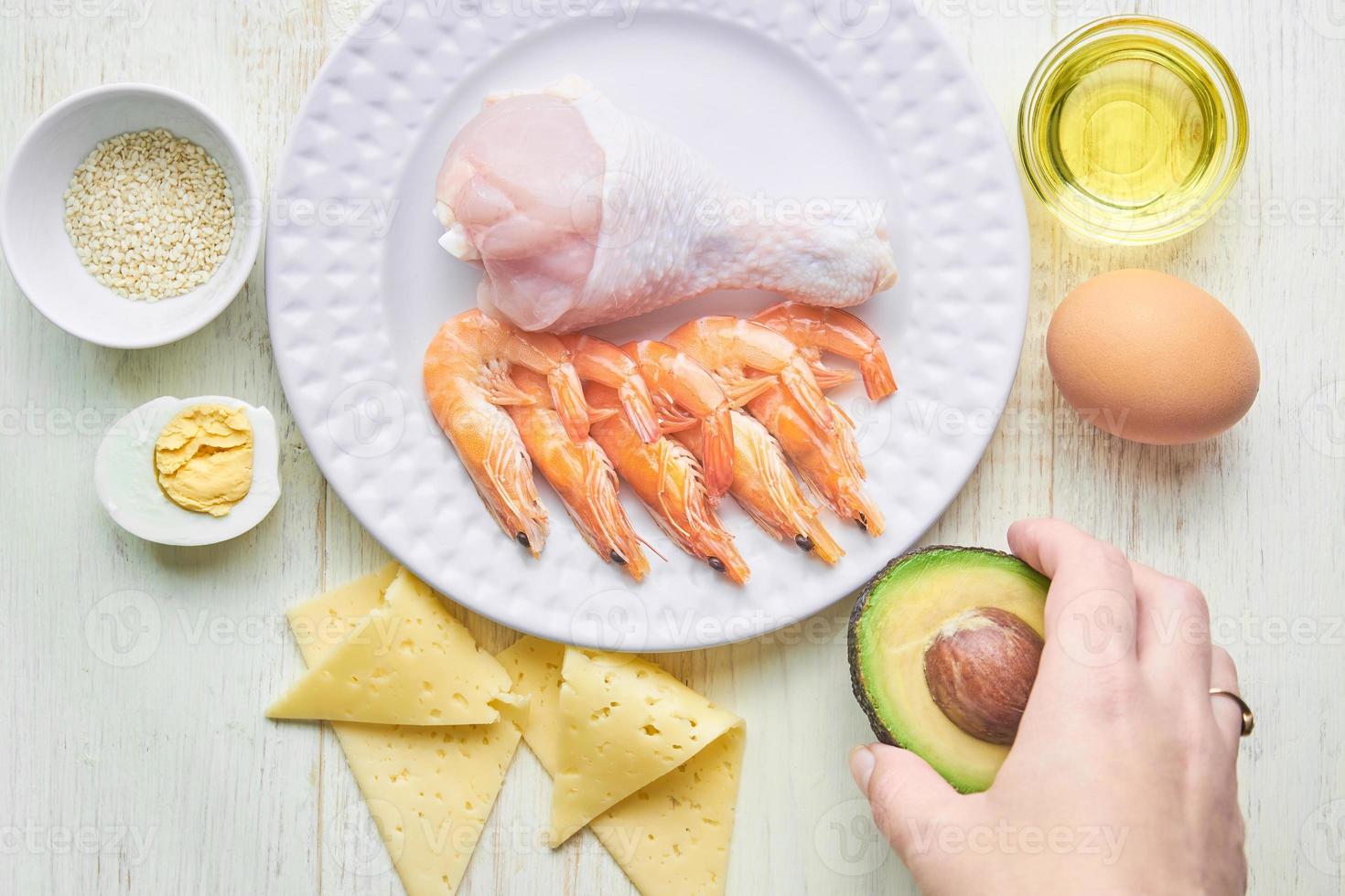 Keto diet concept. Ketogenic diet food. Balanced low-carb food background. Vegetables, seafood, chicken, cheese, nuts on a white background. photo
