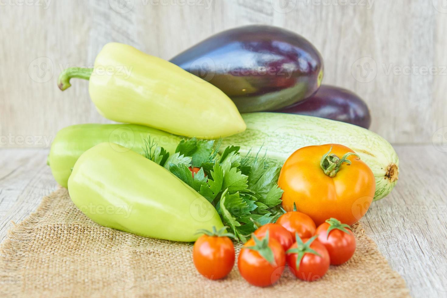 close up of freshly pickled harvest of vegetbles - bell pepper, drill and tomatoes on wooden table. Rustic style. Organic healthy food concept with copy space photo