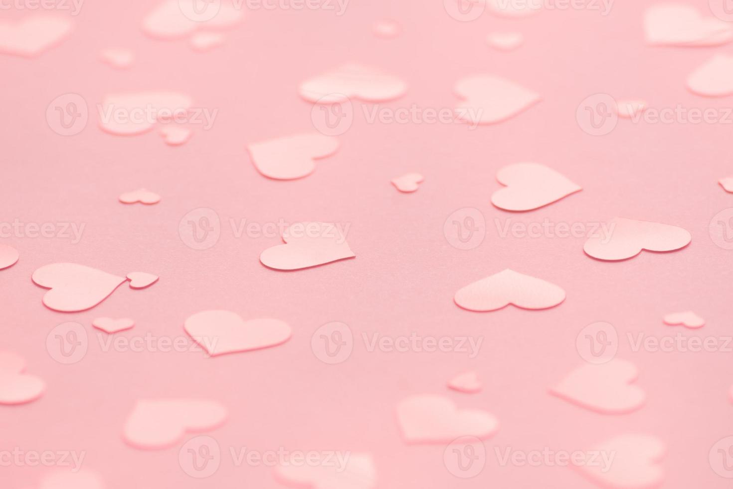 pink background with pink hearts confetti for Valentine's day. Selective focus.  Festive and holiday concept. photo