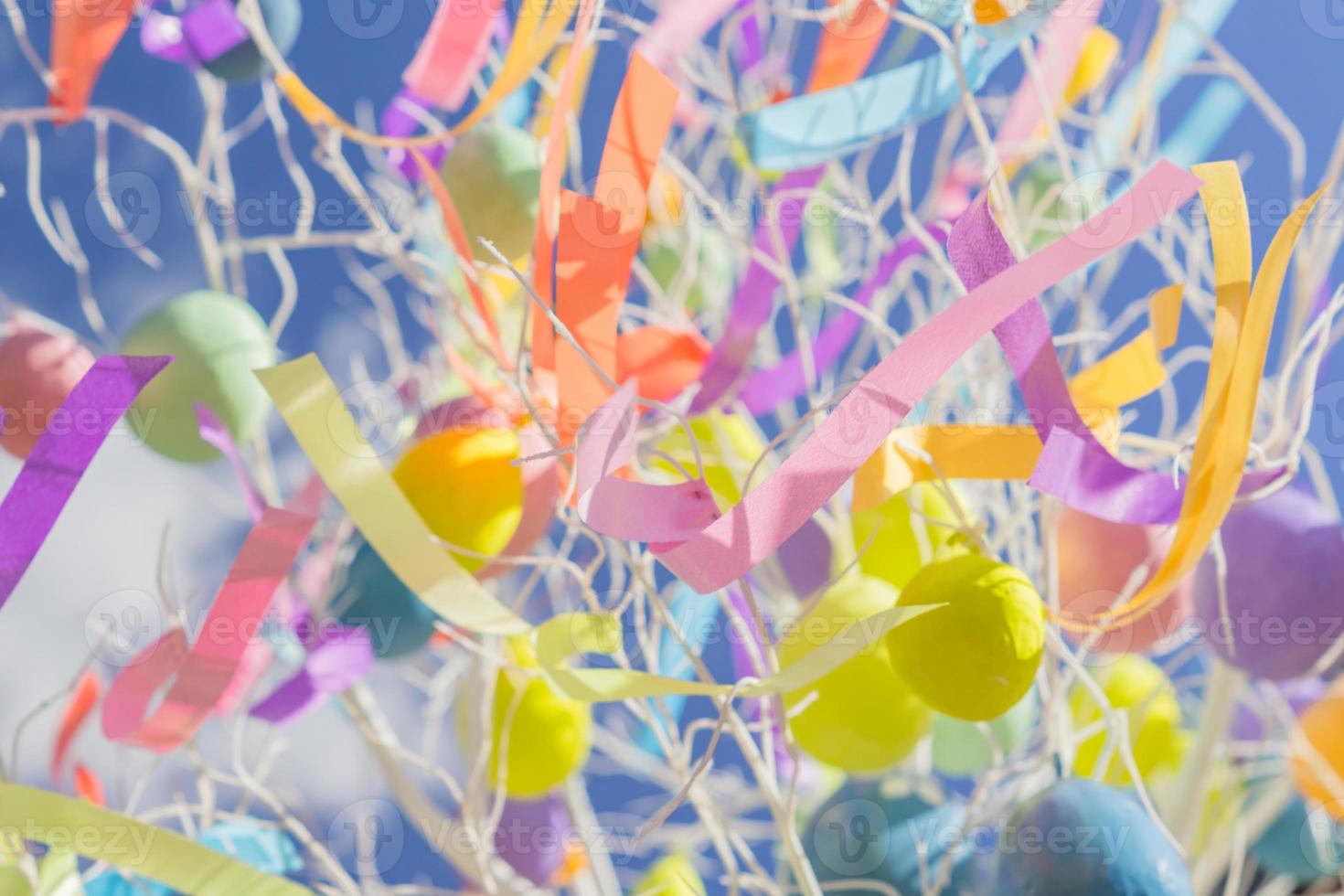 colorfull easter egg tree. brights eggs hanging from branches. photo