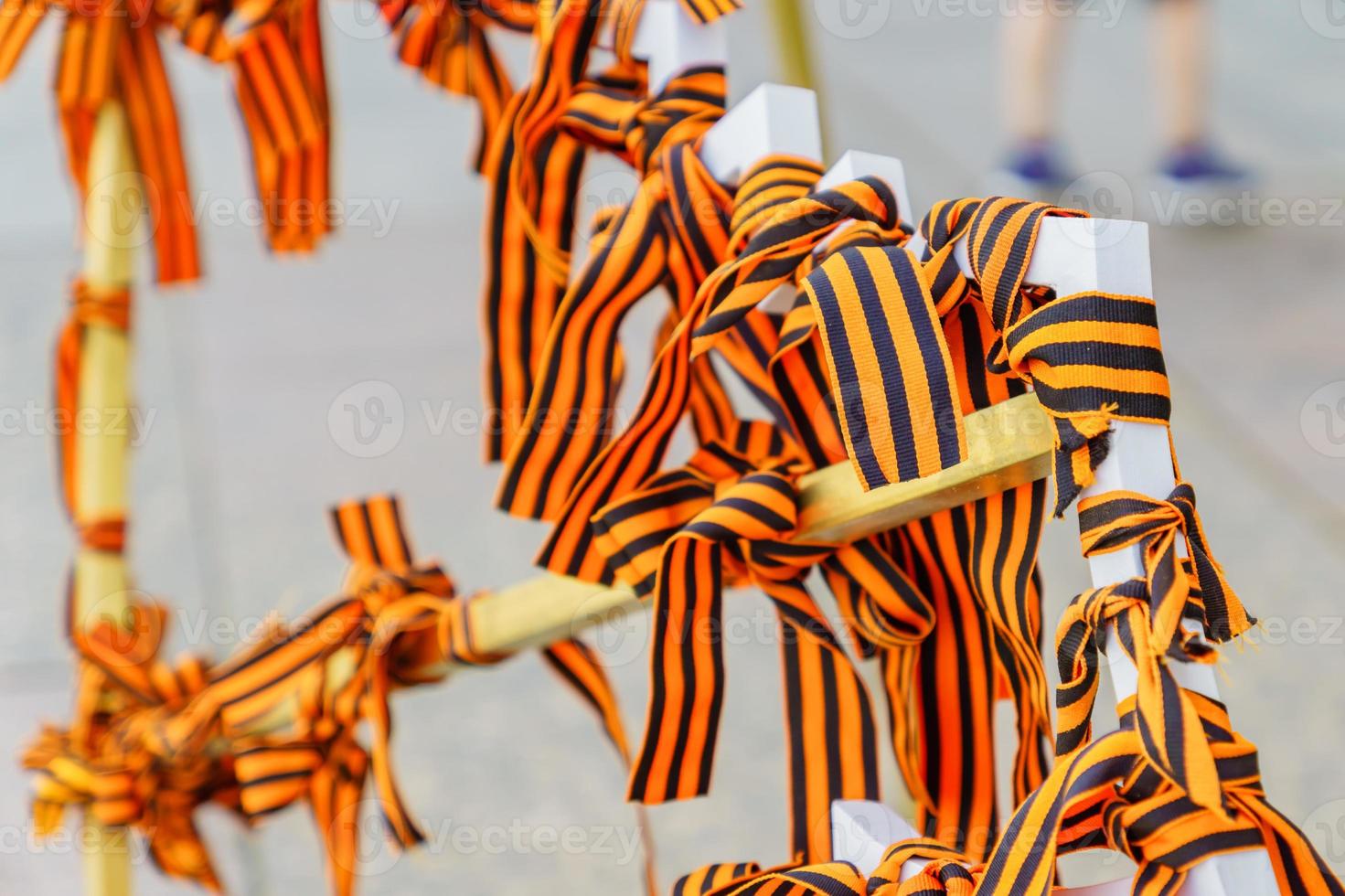 Many of St. George's ribbon tied on the white metal construction as symbol of the Great Patriotic War and Second World war.  May 9. Victory day photo