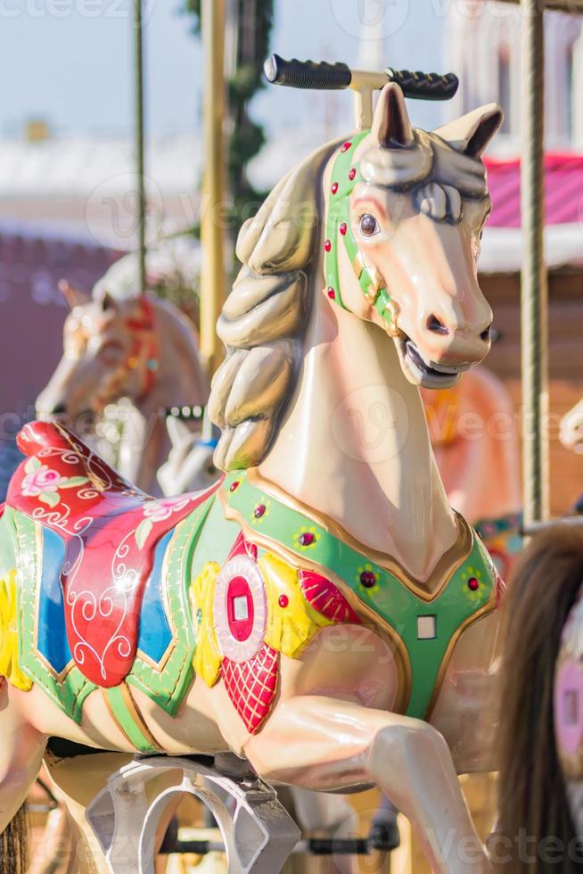Vintage French colorful carousel in a holiday park. Merry-go-round with horses. photo