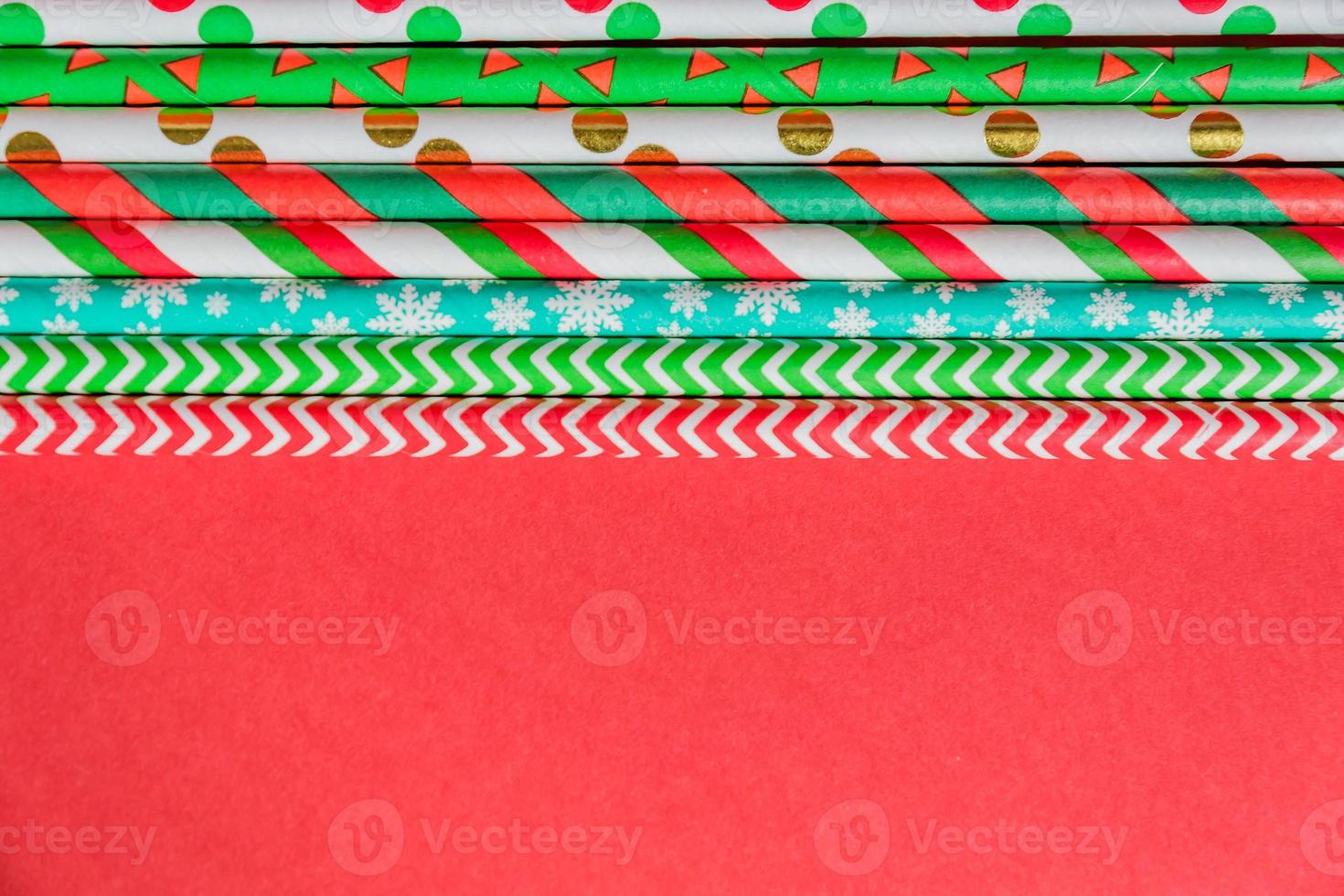 New Year Christmas background. Celebration drinking cocktail party straws ion red background. Template greeting card text design photo