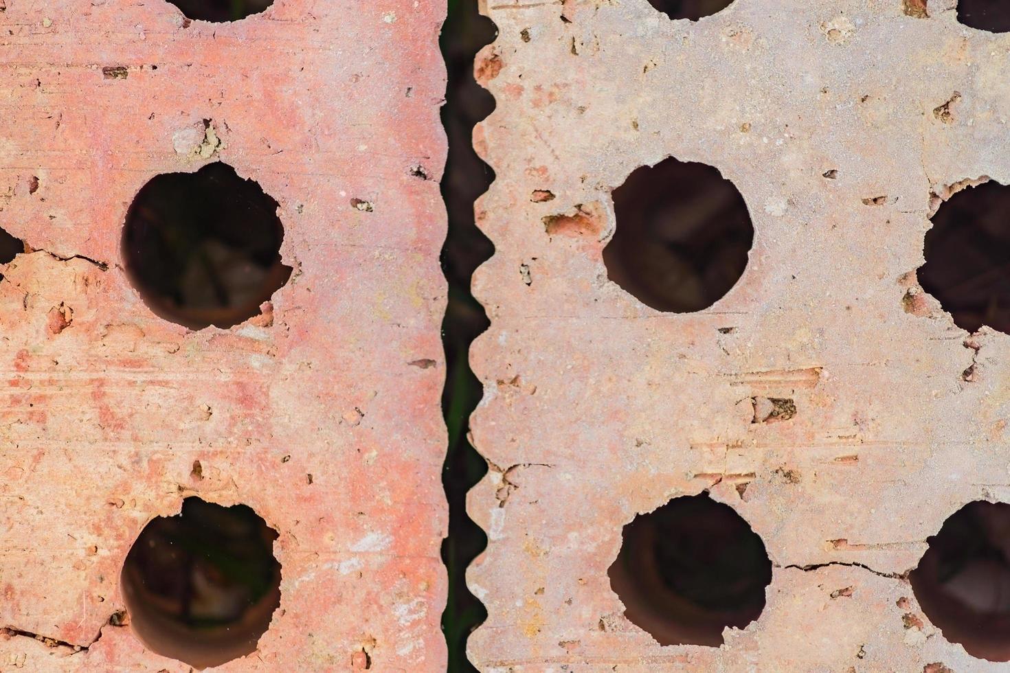 close up of red bricks with holes. Textured background photo