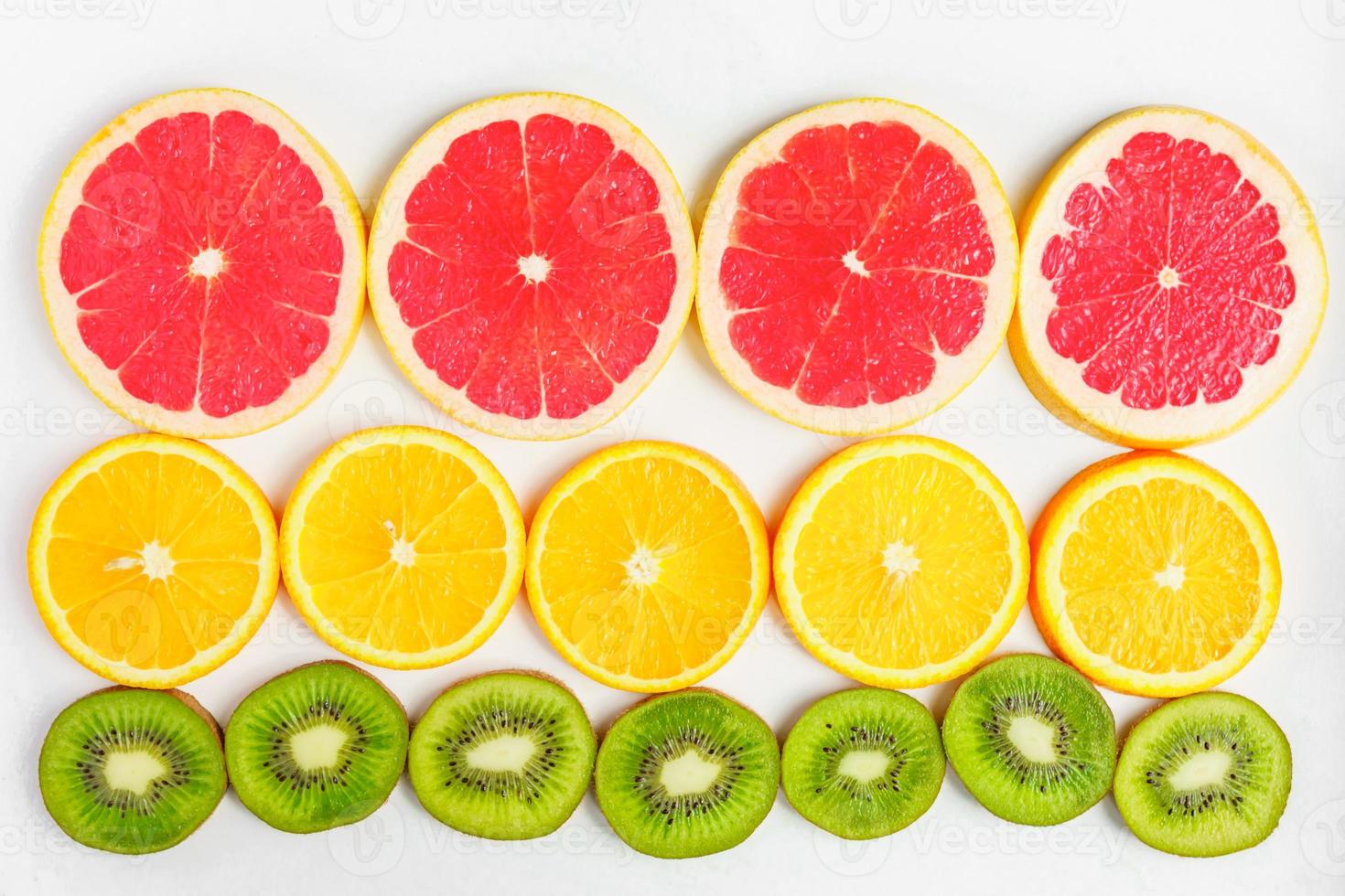top view of citrus slice, kiwi, oranges and grapefruits isolated on white background. Fruits backdrop, selective focus photo