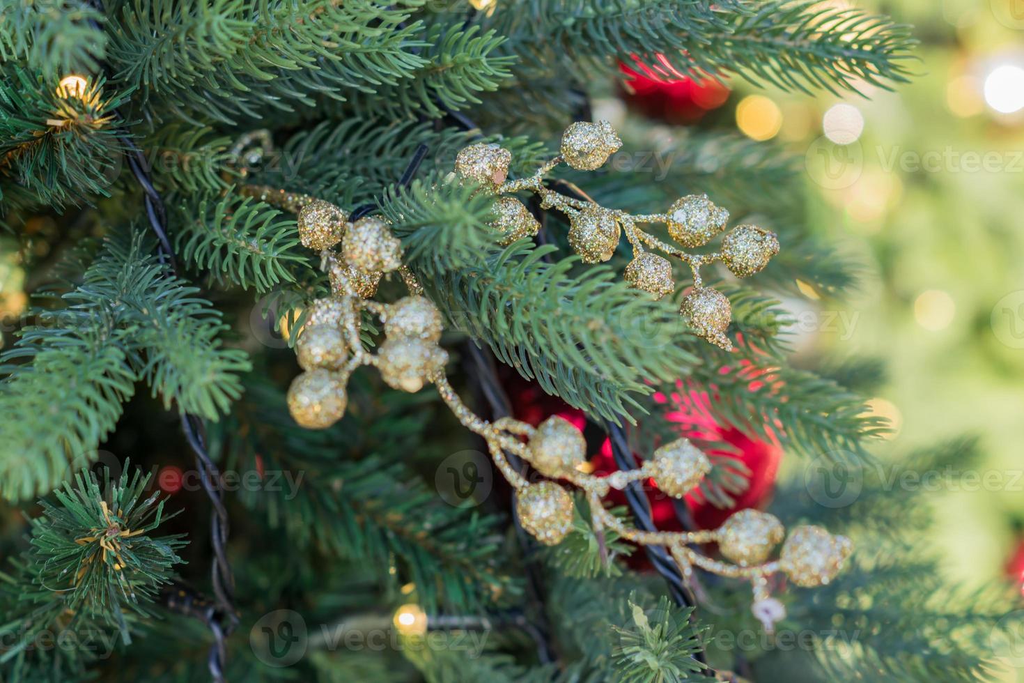 close up of christmas tree decorated with gold small balls. New year background photo