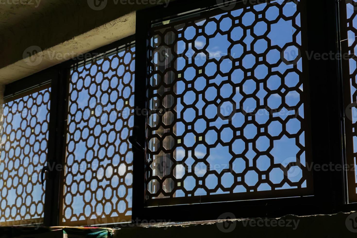 windows with orient ornament made of metal, from the inside photo