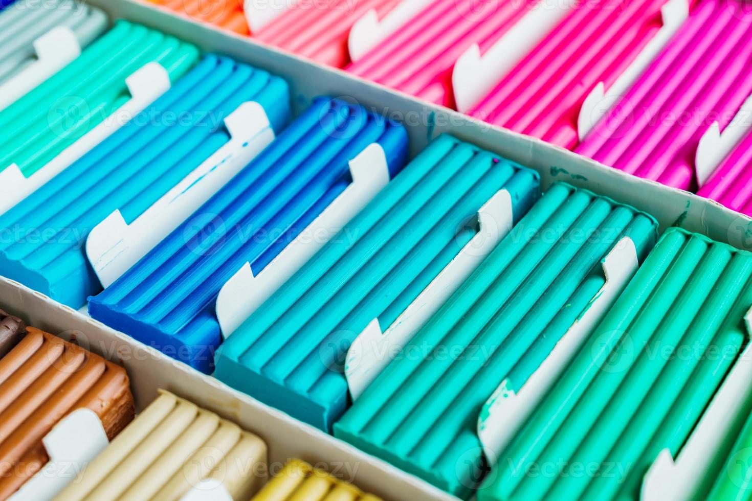 Rainbow colors of modeling clay. Multicolored plasticine bars ina box, background texture photo