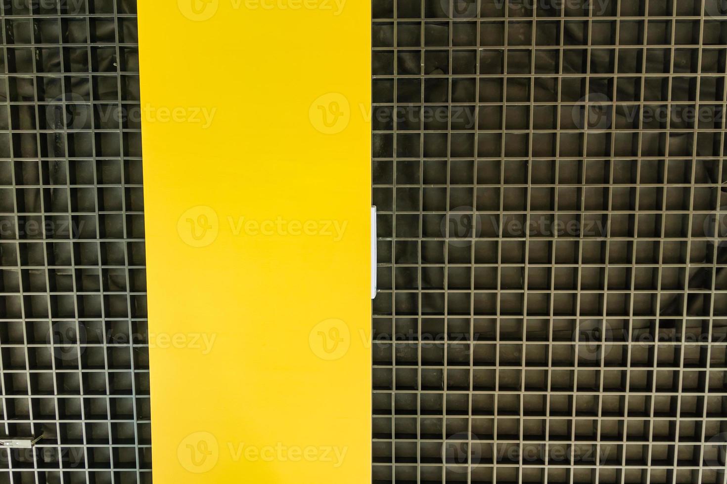 Bottom view of modern black ceilng with yellow panel. Interior design. Background photo
