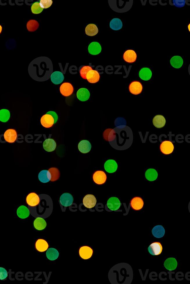 Multicolored abstract bokeh on black background photo