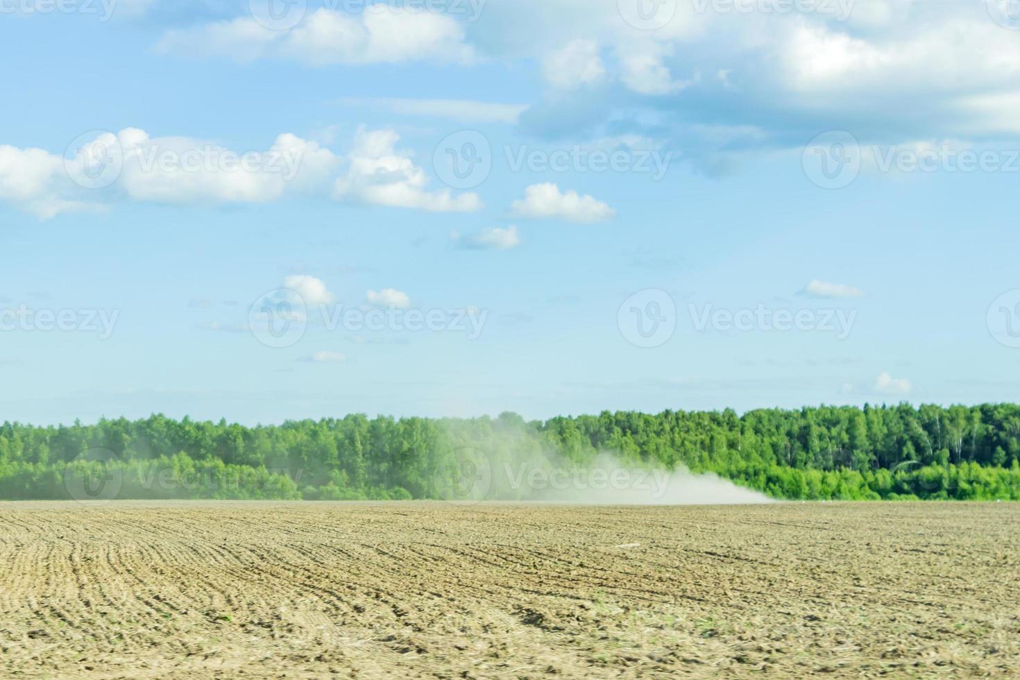 rural landscape in summer sunny day. Agricultural works in the field photo