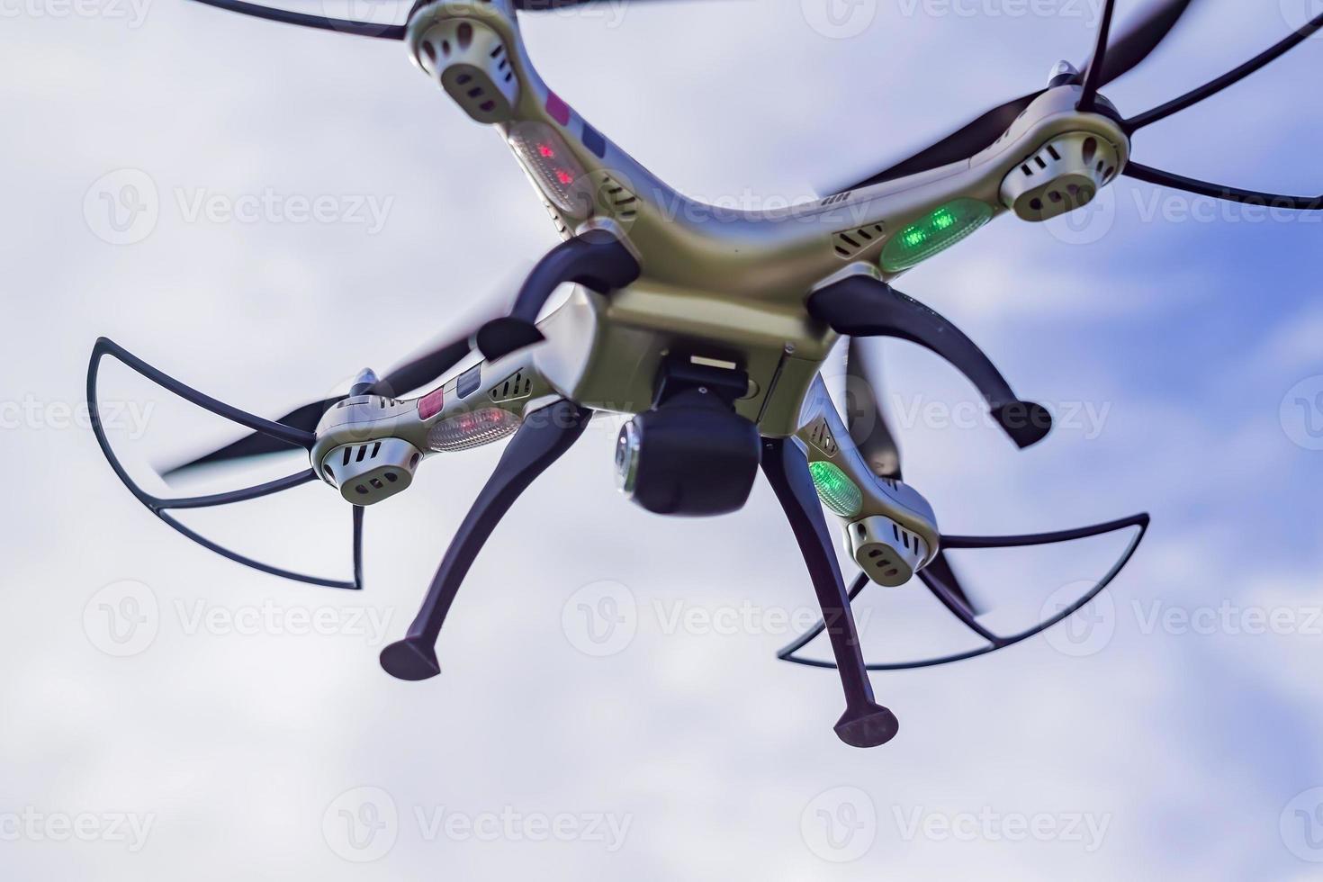 flying drone with remote control against blue sky background. photo