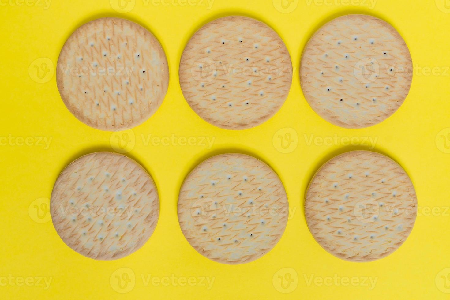 tasty round cookies on yellow backgroud  top view photo