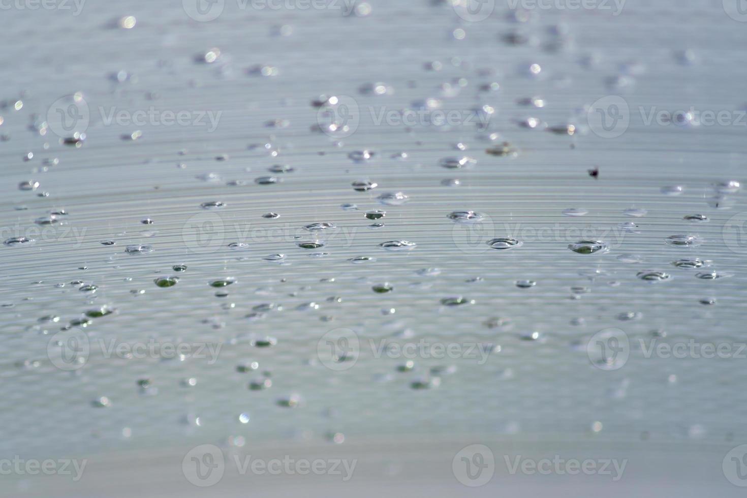Transparent Polycarbonate plastic sheet with drops, background texture with space for text photo