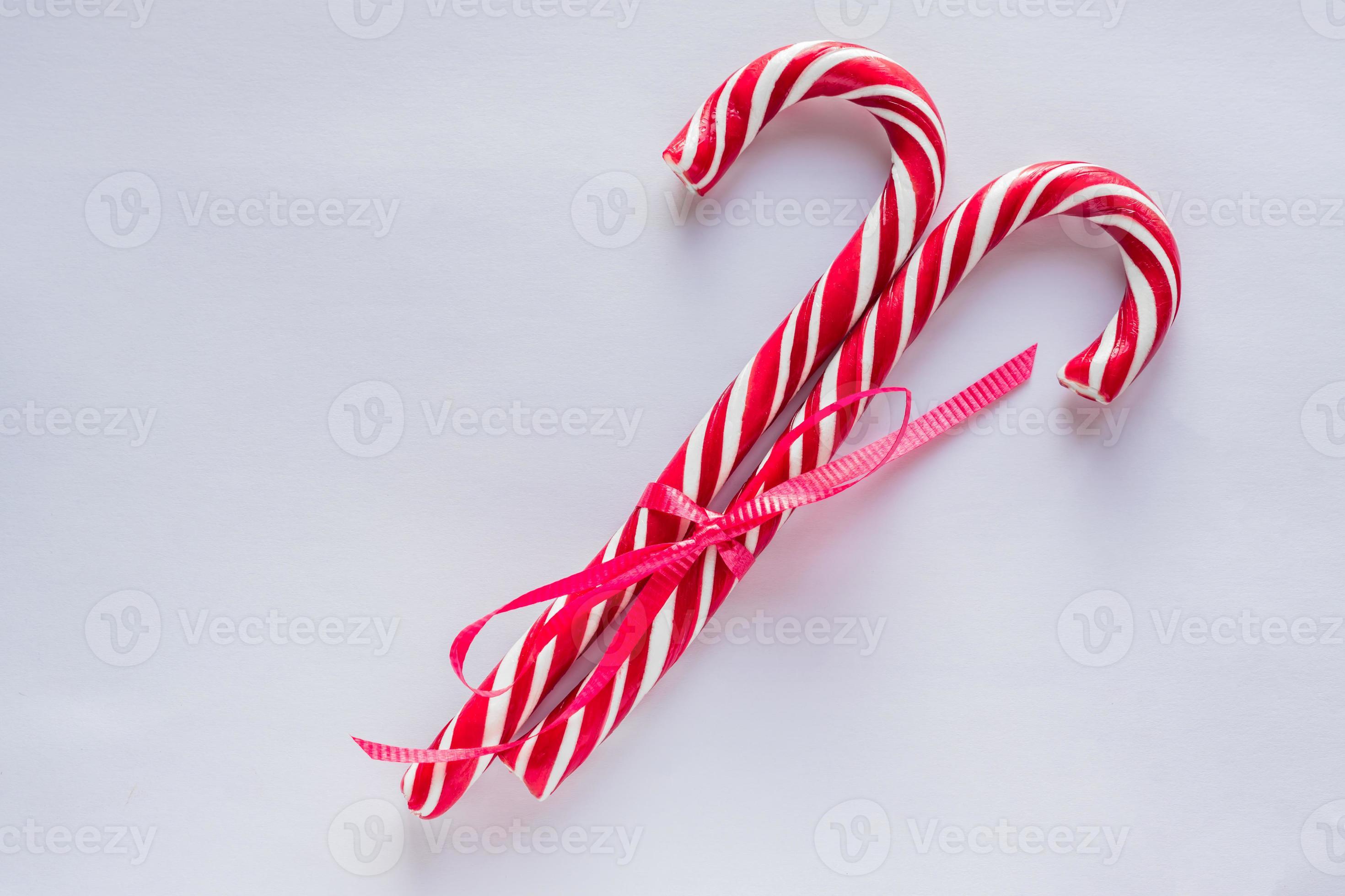 two candy canes on white background. Traditional Christmas candies