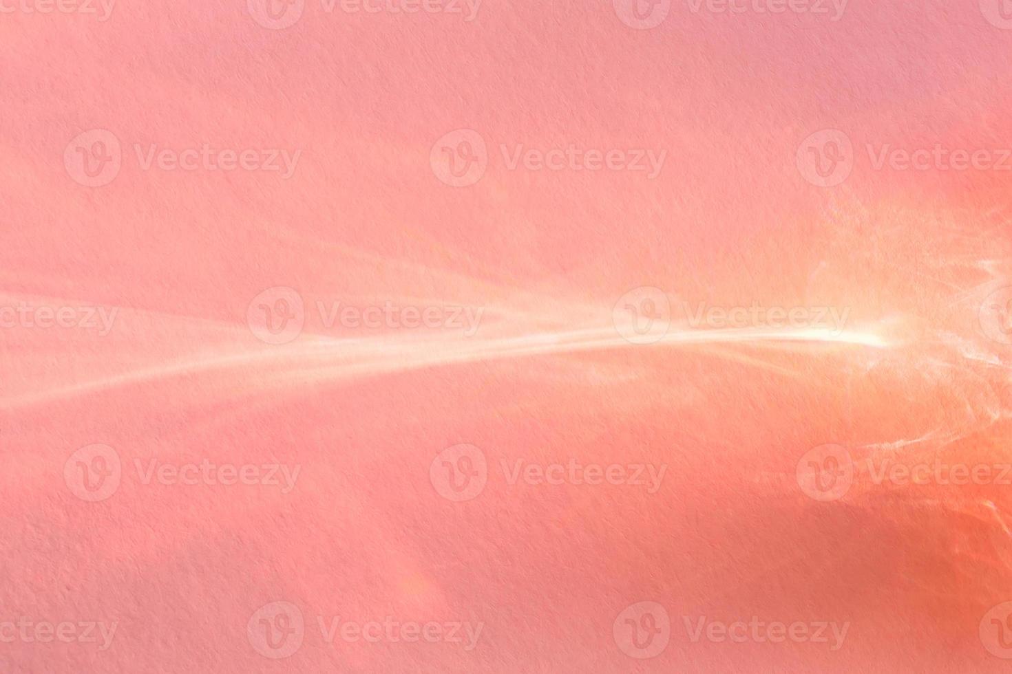 Pink abstract background. Sun beam reflection on paper photo