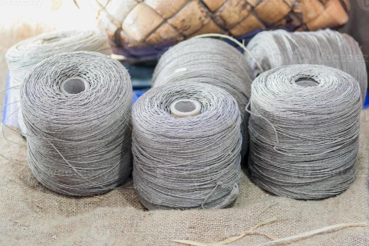 gray silver yarn threads spools bobbin close up. sewing workshop details photo
