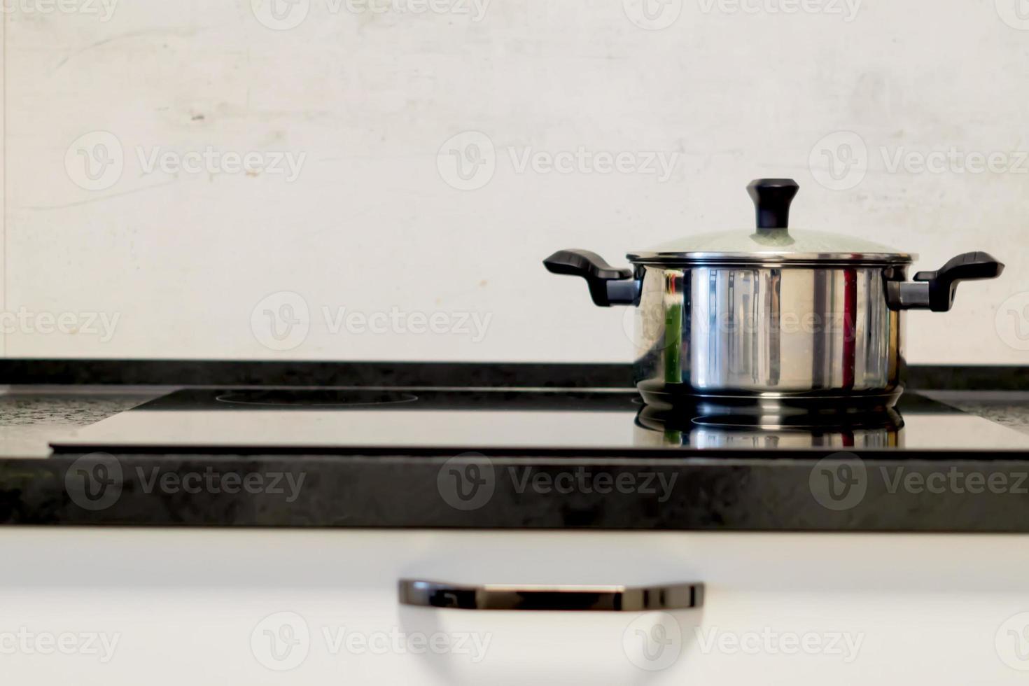 steel pot on electric stove, modern black and white kitchen photo