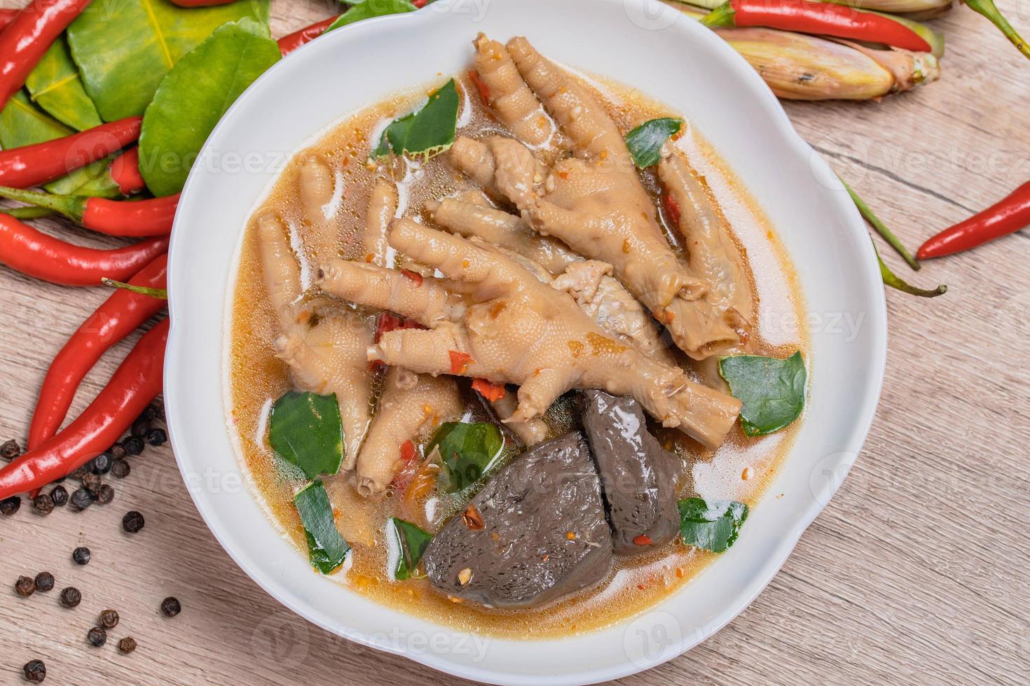 Spicy Stewed Chicken Feet Tom Yum with Fresh Chili, Lemongrass, Kaffir Lime Leaves photo