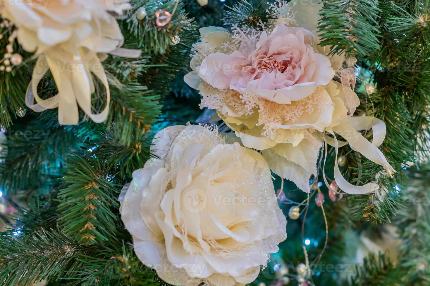 close up of christmas tree decorated with tender pink flower. photo