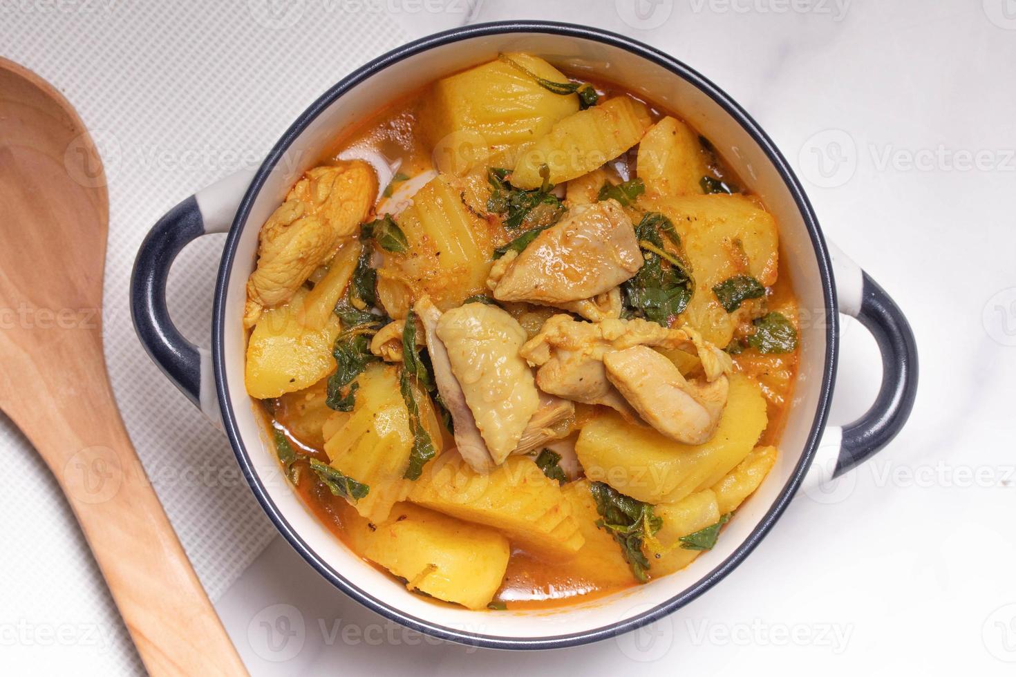 Chicken and Potato Curry with Basil Leaves in a Thai White Bowl photo