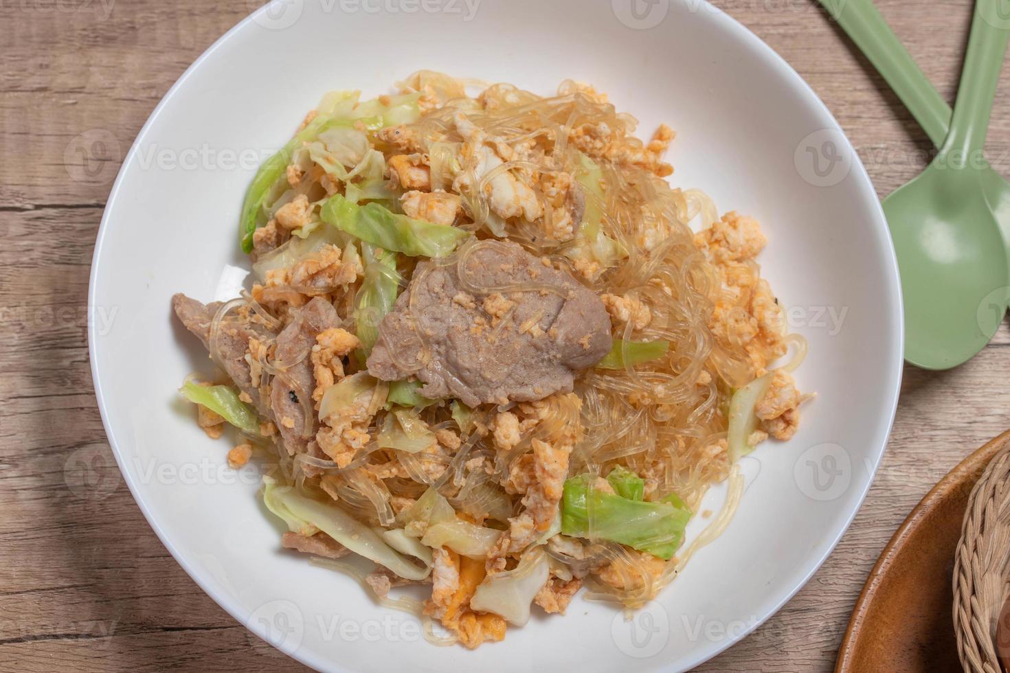Stir fried vermicelli with pork, egg and collard greens in a white