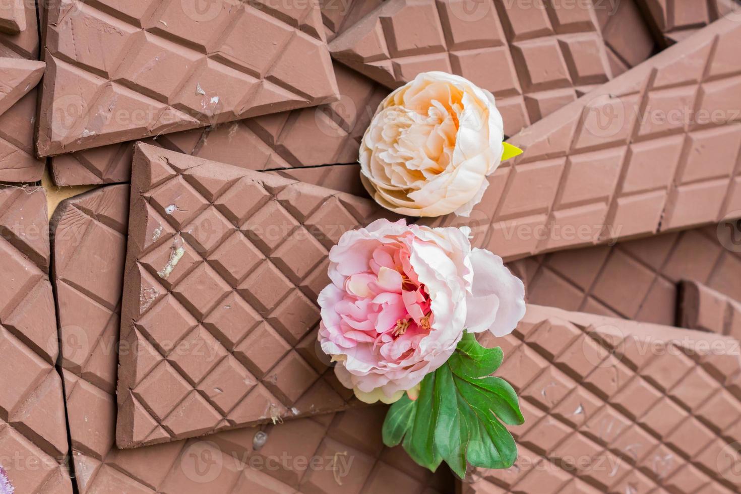two artificial blooming peonies  on broken tile background. photo