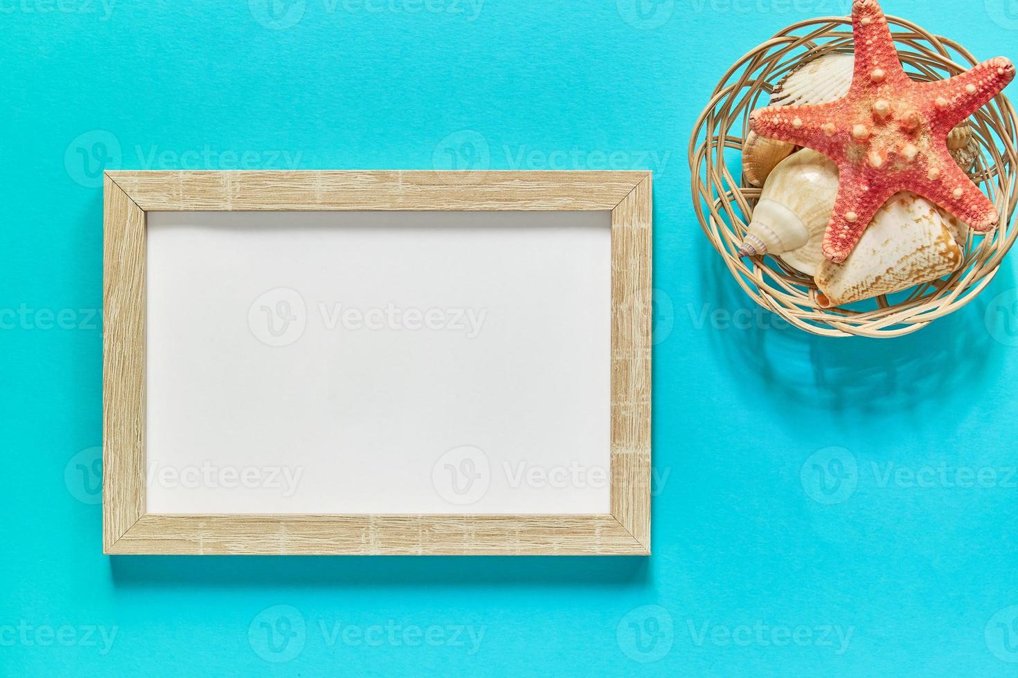 mockup photo frame with a star fish on blue background